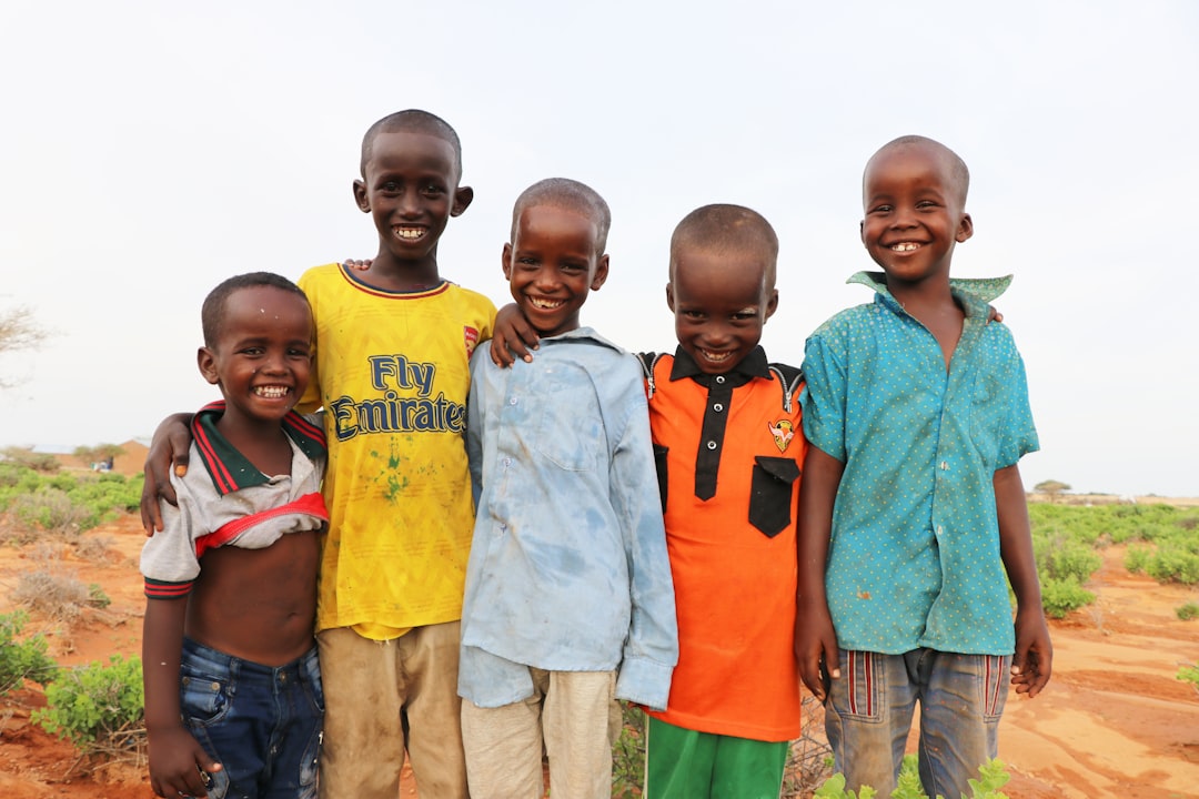 3-boys-and-2-girls-standing-on-green-grass-field-during-daytime-cvkwxr-4-r0